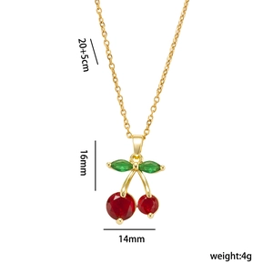 Golden cherry pendant necklace with red heart fruits and green leaves on white background