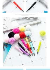 Detailed close-up of vibrant beaded ballpoint pens featuring soft fluffy pom-poms and rhinestones