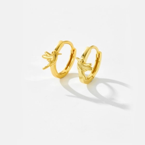 Polished gold hummingbird hoop earrings featuring a minimalist animal design on white backdrop