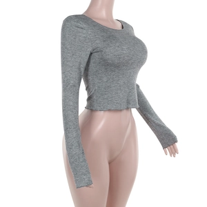 Detail view of grey long sleeve crew neck crop top in ribbed knit fabric on mannequin