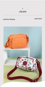 Close-up of waterproof nylon crossbody bags in solid orange and colorful abstract patterns