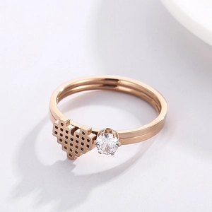 Macro shot of rose gold ring with pixelated heart design and sparkling round crystal stone