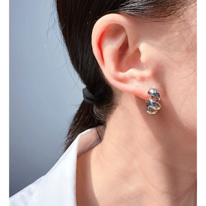 Classic silver twisted hoop earrings with a polished finish worn by a model