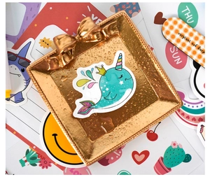 Waterproof cartoon stickers with unicorn and shark patterns on a gold bow tray