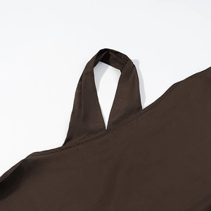 Close-up of bohemian brown top showing detailed shoulder strap and textured fabric