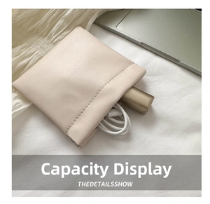 Mini beige faux leather pouch with squeeze closure showing lipstick and cable storage