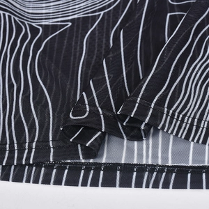 Detail view of the breathable mesh fabric with black and white striped flocking patterns