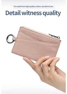 Close-up of pink litchi grain leather card holder with silver zipper and metal ring detail