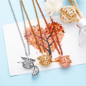 Three hollow spherical pendant necklaces in gold, silver and rose gold with angel wings