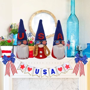 Three USA Independence Day gnomes with flag sunglasses on white marble mantelpiece