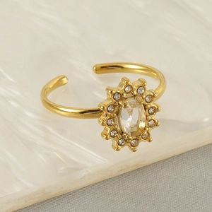 Macro shot of gold adjustable sunflower ring featuring a central oval diamond and zircon