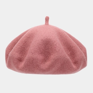 Detailed close-up of pink wool felt beret top with classic stem on neutral background