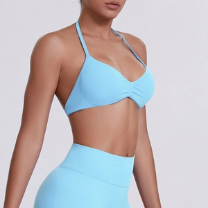 Detail of light blue ribbed sports bra with halter neck and seamless stretch fabric