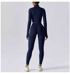 Rear view of slim fit navy yoga set featuring long sleeve crop top and high waist leggings