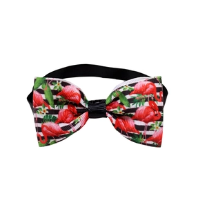Detail of pet bowtie featuring flamingo print and black-white stripes with adjustable strap