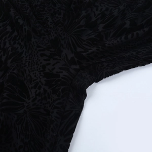 Close-up of the black flocked burnout fabric texture and stitching on long sleeve bodysuit