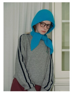 Close-up of sky blue knitted balaclava hood featuring delicate floral embroidery details