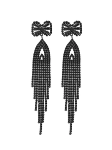 Macro shot of elegant black tassel earrings with a bow top and sparkling rhinestones