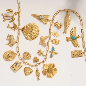 Gold stainless steel charm necklace with ocean, animal, and eye pendants collection