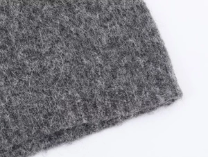 Macro shot of gray wool blend knit fabric showing soft texture and high-quality fibers