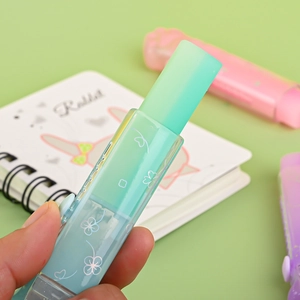 Blue-green cat paw gradient sliding eraser with holographic clover in hand for school
