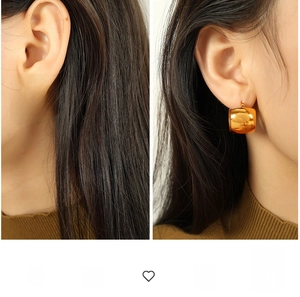 Detail view of gold chunky hoop earrings showing spiral texture and smooth polished finish