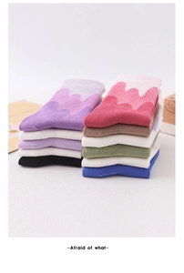 Detail of ribbed knit texture on colorful gradient crew socks in various pastel colors