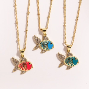 Detailed shot of enamel fish pendants in red, blue and green on beaded gold necklaces