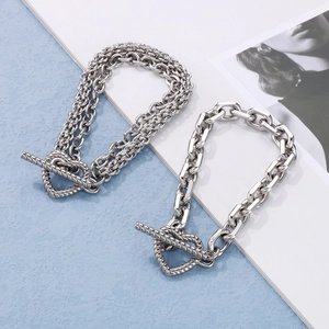 Detail of silver double-layer and chunky chains featuring unique heart-shaped T-bar toggles