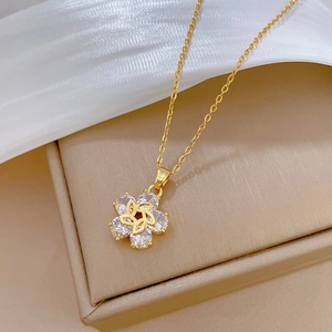 Detail of spinning floral gold necklace with sparkling crystals on premium silk fabric