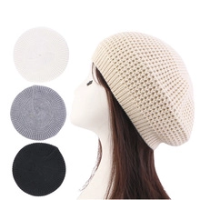Detail showing knit berets in beige, white, grey, and black with braided textures