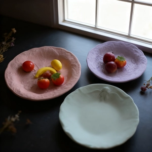 Detailed relief fruit pattern on round resin trays in pastel morandi colors