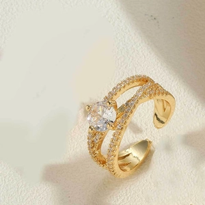 Close-up of vintage gold ring with large clear zircon center stone and pave accents