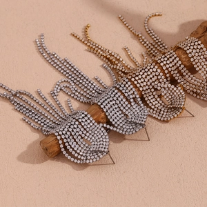 Detailed view of layered 18K gold plated tassel earrings with sparkling zircon stones