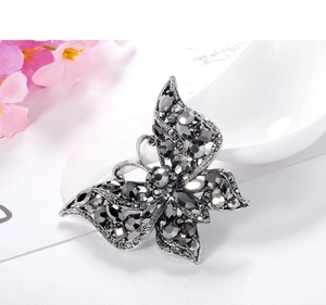 Detailed close-up of a vintage butterfly brooch with grey and black sparkling rhinestones