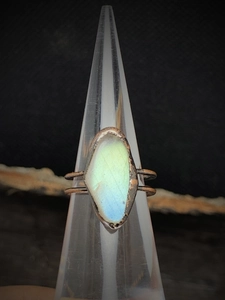 Macro detail of vintage adjustable ring featuring an irregular iridescent gemstone setting