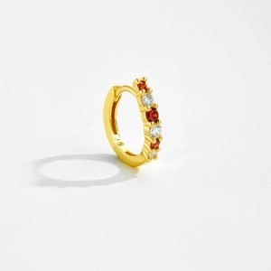 Detail of gold S925 silver hoop earrings with white and orange zircon stone settings