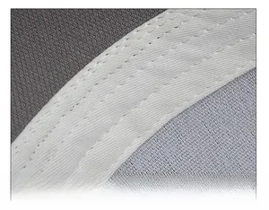 Detail of white sweatband and grey breathable mesh fabric with fine stitching