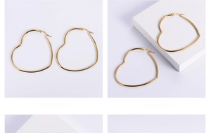 Macro shot of large heart-shaped hoop earrings in polished gold titanium steel