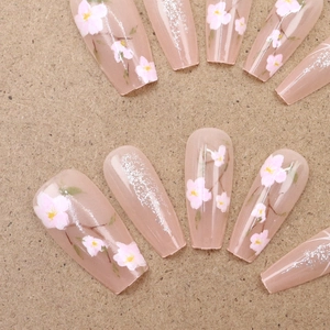 Pink cherry blossom press-on nails in long coffin shape with silver glitter accents