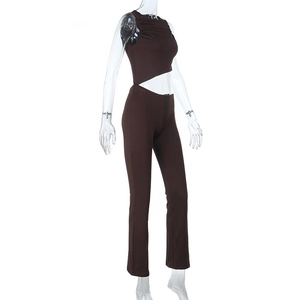 Détail d'un haut sans manches ajouré marron foncé et d'un pantalon évasé à taille haute