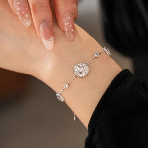 Detail of 18K gold plated bracelet with starburst pendant and pavé cubic zirconia