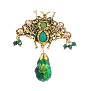Vintage gold bee brooch with emerald green stones and elegant hanging drop pendants