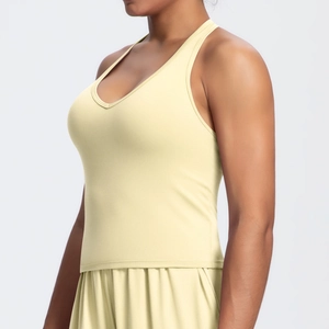 Detailed side view of yellow sports bra with tight V-back design for fitness training