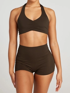 Detail view of the dark brown halter neck sports bra and high-waisted yoga shorts set