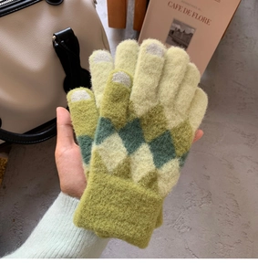 Detail of green and yellow diamond knit pattern on touchscreen winter gloves for women