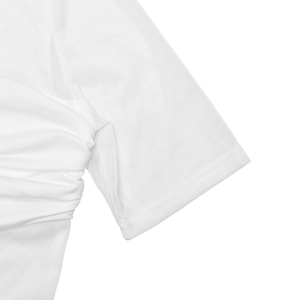 Detailed macro view of sleeve cuff stitching and white pleated fabric texture on dress