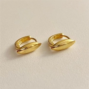 Close-up of golden olive-shaped earrings showing S925 sterling silver hallmark engraving