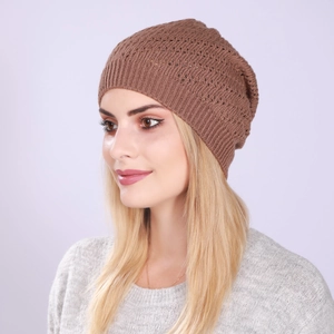 Close-up of brown hollow-out crochet knit beanie with ribbed cuff on model