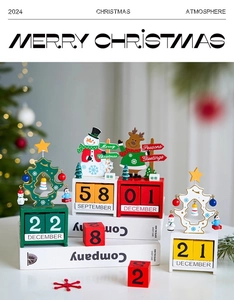 Close-up of wooden Christmas calendar set with snowman and reindeer on white books